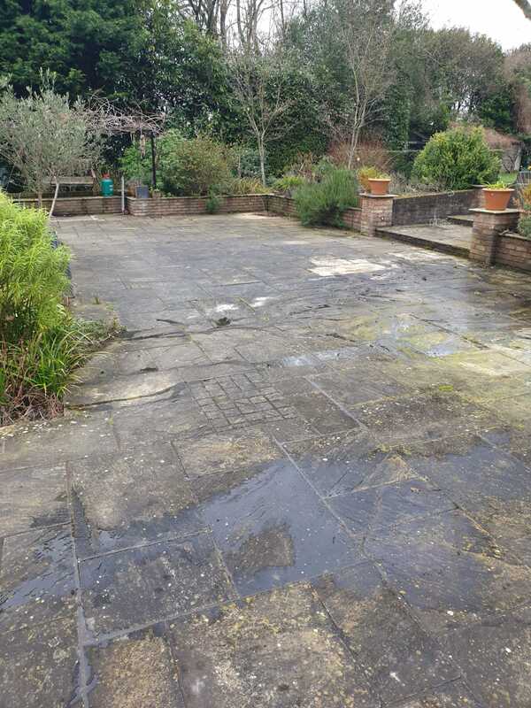 Image of patio before pressure washing treatment